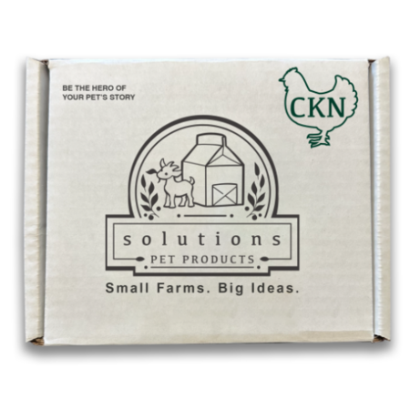 A square cardboard box for pet products, shown closed against a white background. The box is a warm off-white/cream color with black line art and text, plus a green outline CHICKEN logo with the word 'CHICKEN' inside.