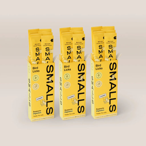 Three yellow boxes of Smalls Bird Licks Chicken Recipe lickable cat treats, with individual treat sticks visible above each box.