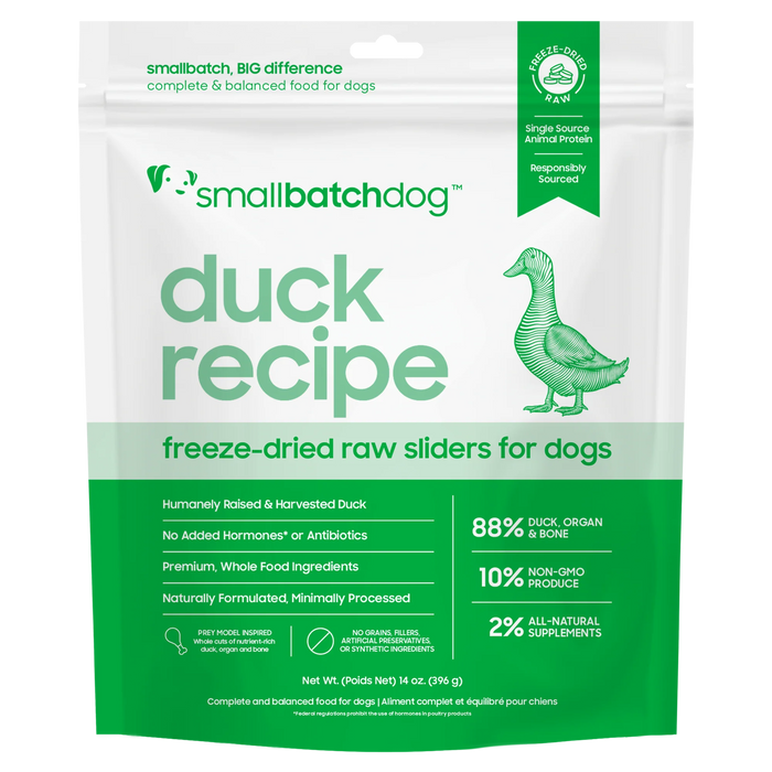 A stand-up pouch of Small Batch Dog 'Duck Recipe' freeze-dried raw sliders for dogs, featuring a green and white design with a green duck illustration and product details.