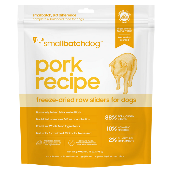 A stand-up pouch of smallbatchdog pork recipe freeze-dried raw sliders for dogs, featuring a white and orange design with a yellow-orange title and a line drawing of a dog.
