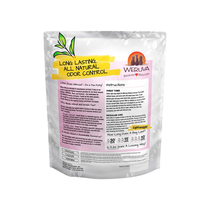 Back of Weruva clumping cat litter packaging. Made with hinoki wood and green tea, white-and-pink bag with a cartoon cat sand green leaves.